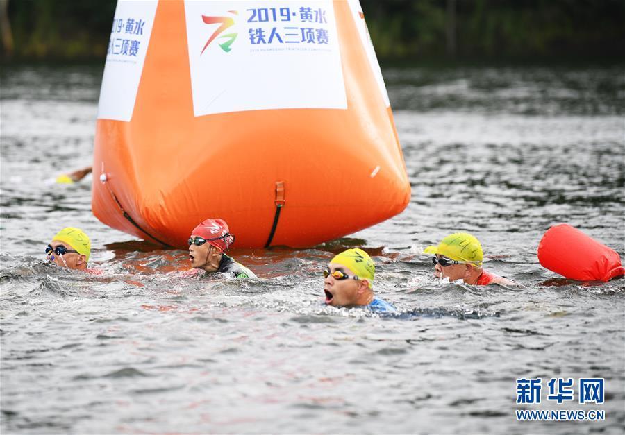 7月25日,中国选手曹俊宇在全程铁人三项赛游泳项目比赛