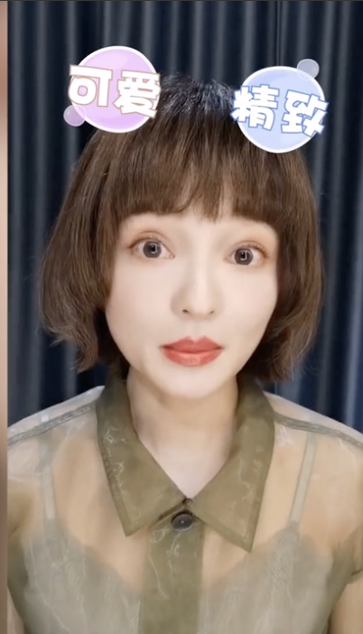 张韶涵栗色短卷发干净利落 穿绿色薄纱上衣皮肤白皙