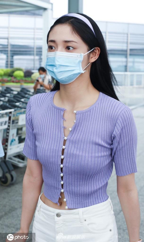 周洁琼穿香芋紫短T现身机场 温婉妩媚小秀性感