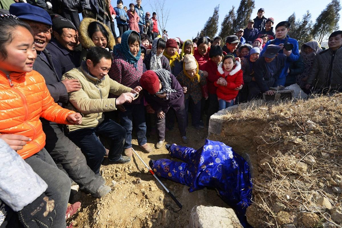 4 山东66岁老农自办"活人出殡" 穿寿衣钻坟墓