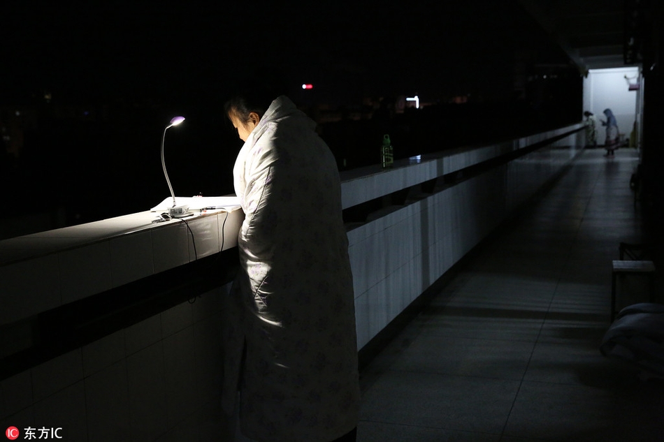 大幅降温后考研生裹毛毯楼道挑灯苦读