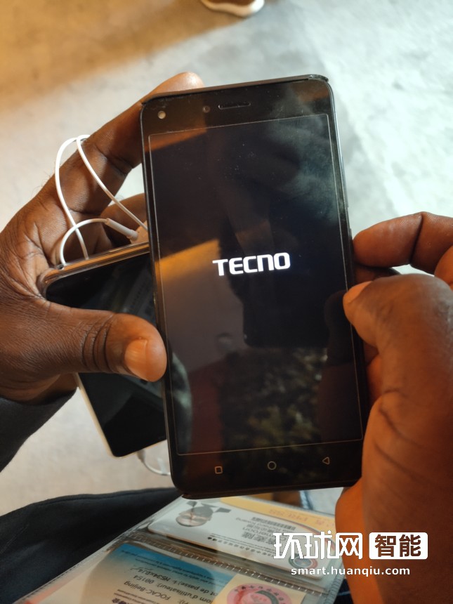 Kometa Richard Kwang向记者展示TECNO品牌手机