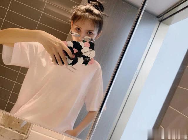 张予曦吃着美食开心甜笑，一桌的美食与瘦小的她形成反差，这是摆拍的吧