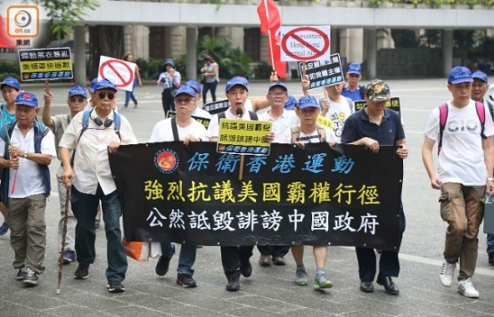示威人士手持“抗议美国霸权”、“违反国际法规”等标语。(图片来源：香港“东网”)