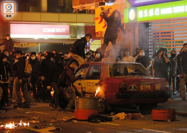 旺角暴乱当晚，有暴徒站在出租车顶，破坏社会秩序。图源：东网
