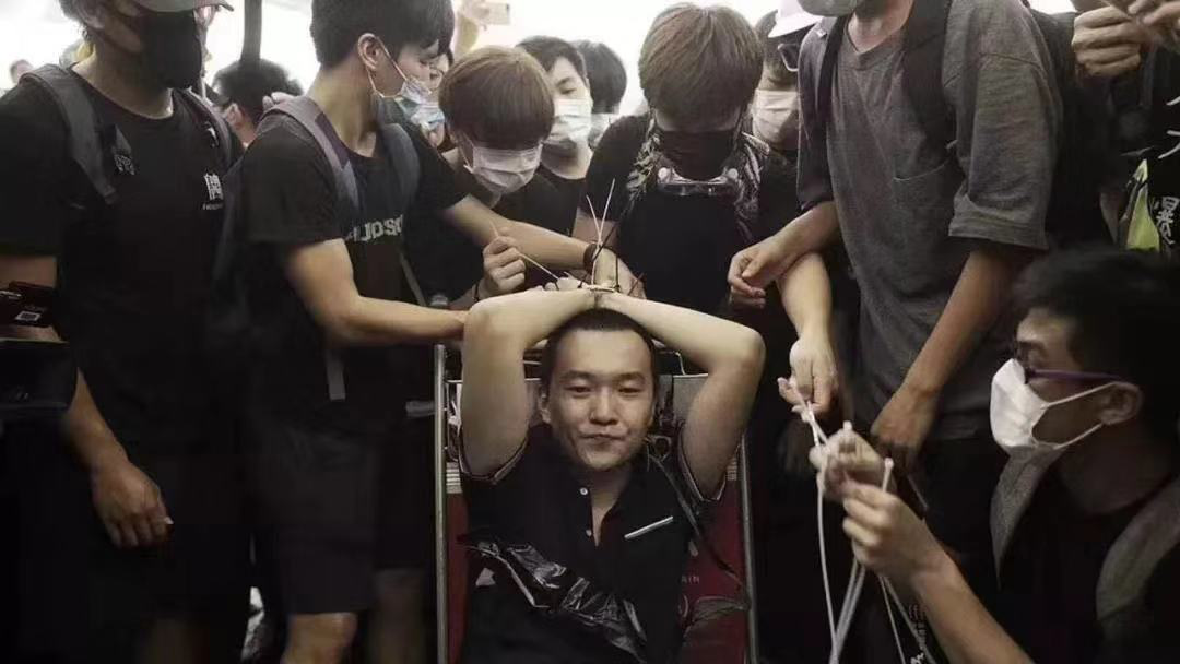 环球网记者付国豪在香港机场采访时遭极端示威者绑架殴打