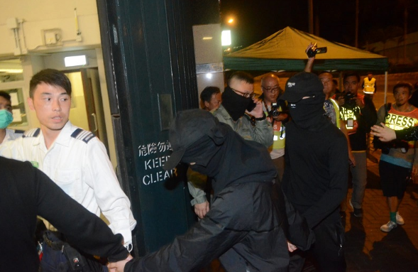 暴徒向警方登记资料后被带往医院(图片来源：香港《星岛日报》)