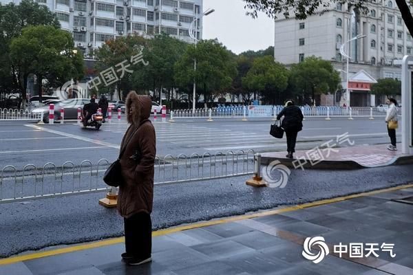 湖南岳阳湿冷难耐,市民冬装出行。(图/周金良)