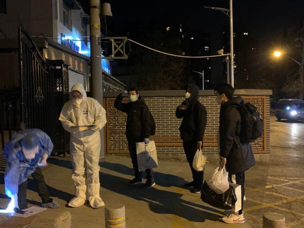 卢岩的儿子(最右)到达隔离点